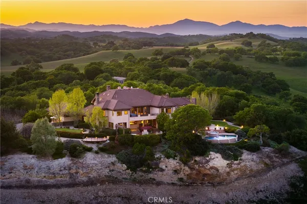 an aerial view of a house with swimming pool garden and patio
