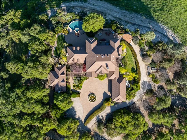 a aerial view of a house with a yard and lake view