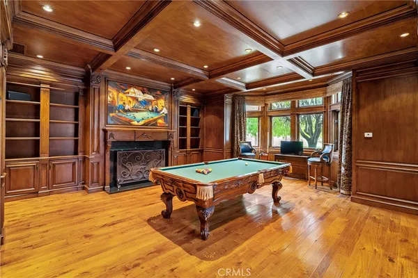a view of a hallway with wooden floor and furniture