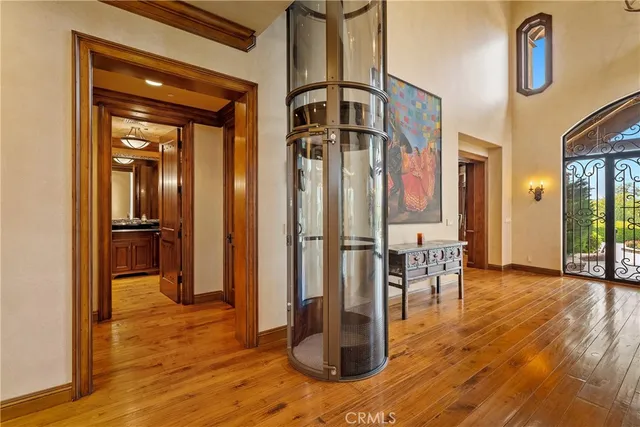 a living room with furniture a large window and wooden floor