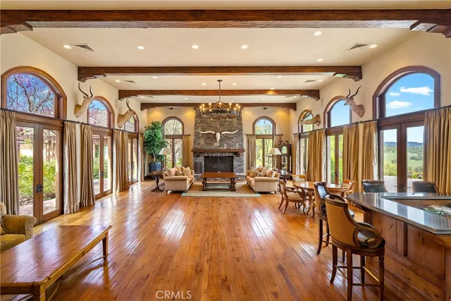 a view of a livingroom with furniture window and wooden floor