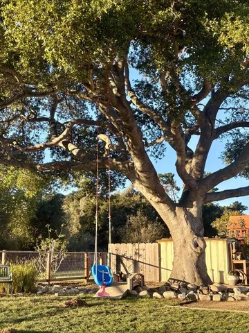 a view of a patio with table and chairs under an umbrella