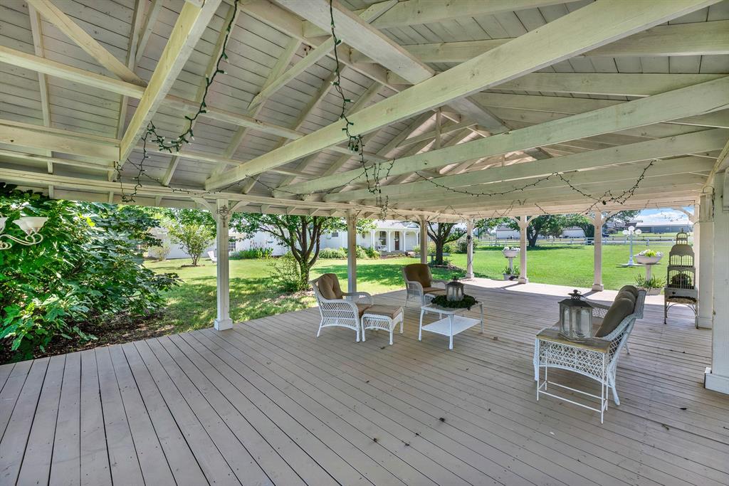 1425 Lone Star Road Celina, TX 75009 - Photo 33 of 40 Inside, the pavilion offers abundant room for seating, dining, and entertaining, creating a natural extension of the outdoor living space. Whether hosting guests or enjoying a quiet afternoon in the shade, this versatile structure provides a comfortable setting with picturesque views across the shared lawn and surrounding property.