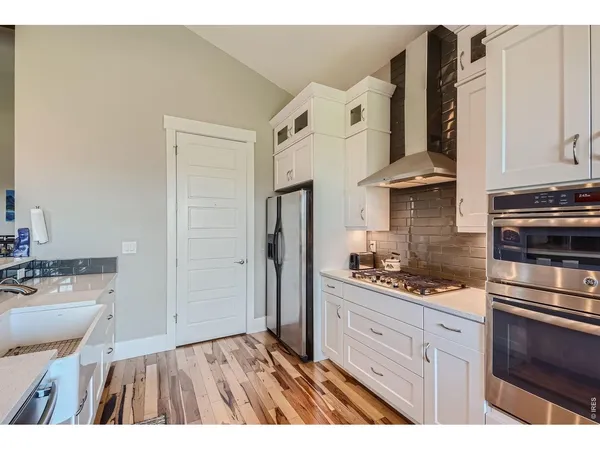 a kitchen with cabinets and stainless steel appliances