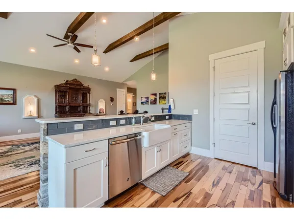 a open kitchen with stainless steel appliances granite countertop a refrigerator and a sink
