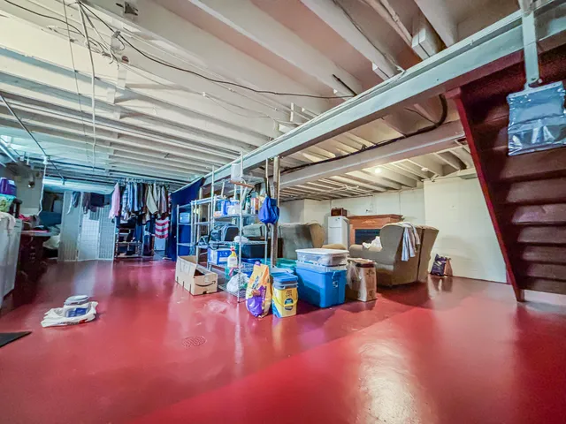 a bedroom with bed and a chandelier