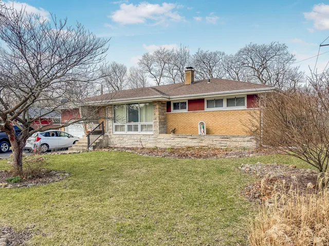 a living room with furniture a flat screen tv and floor to ceiling window