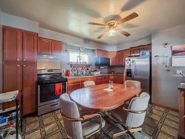 a kitchen with granite countertop lots of appliances and cabinets