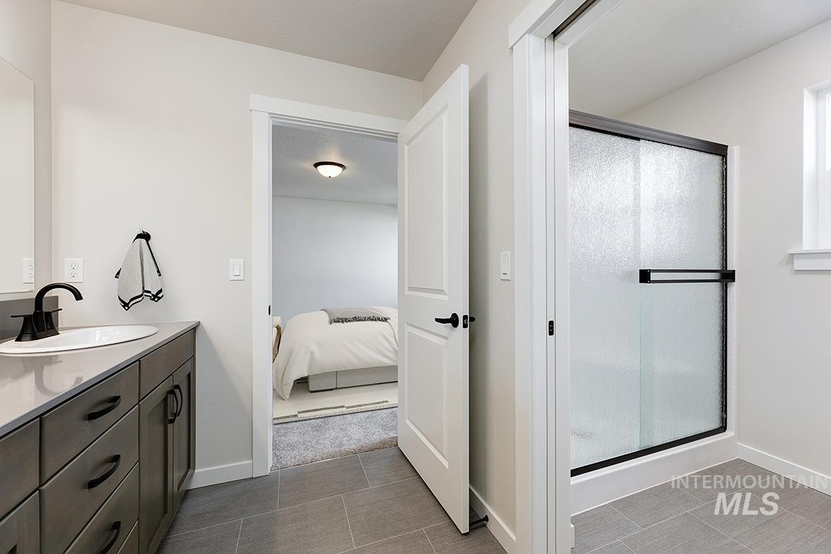 224 West Broyhill Street Meridian, ID 83642 - Photo 12 of 24 Bathroom with vanity, a shower stall, and ensuite bath