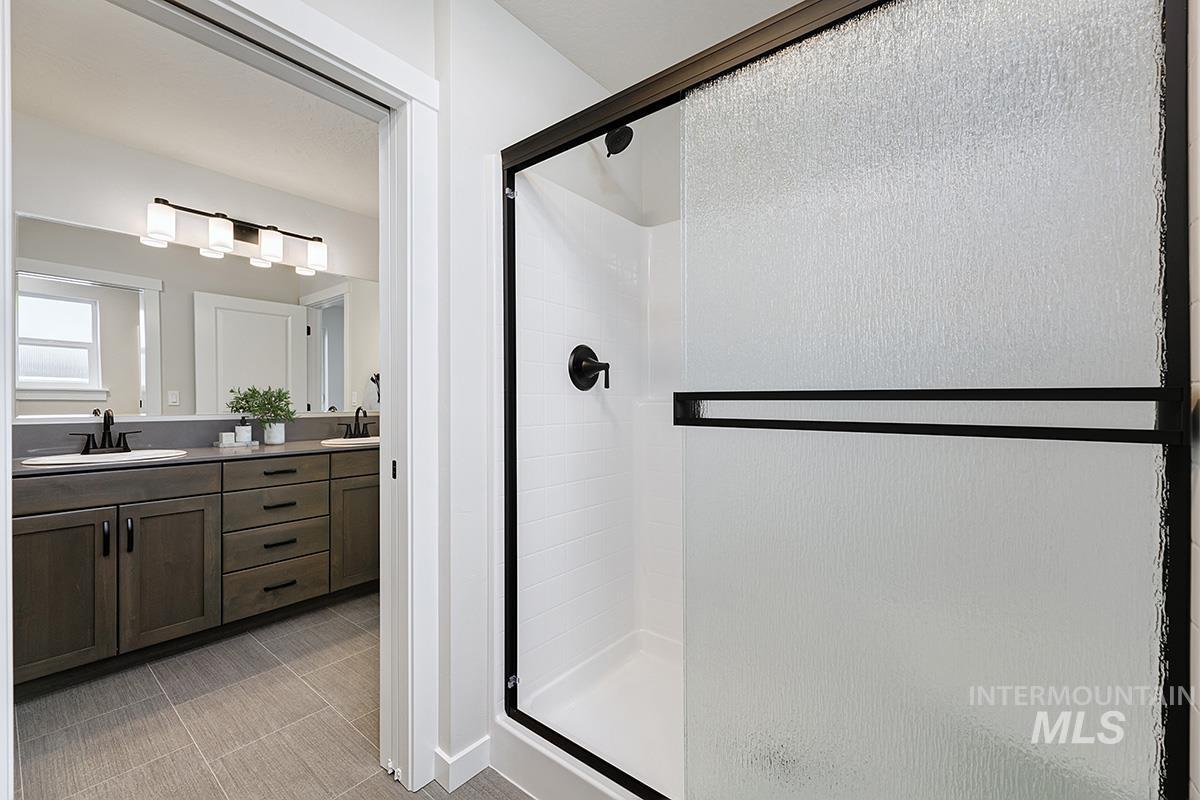 224 West Broyhill Street Meridian, ID 83642 - Photo 13 of 24 Full bathroom featuring a stall shower and double vanity