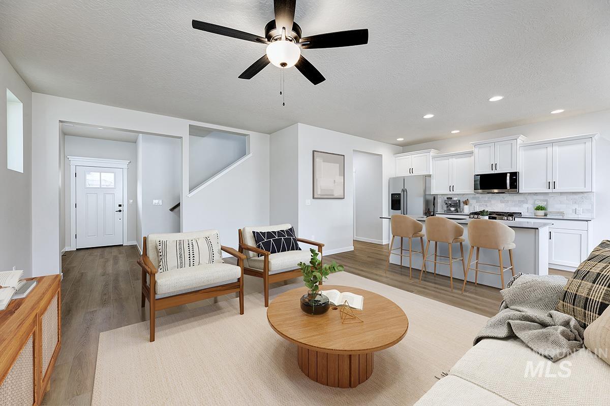 224 West Broyhill Street Meridian, ID 83642 - Photo 3 of 24 Living room with a textured ceiling, light wood finished floors, ceiling fan, and recessed lighting