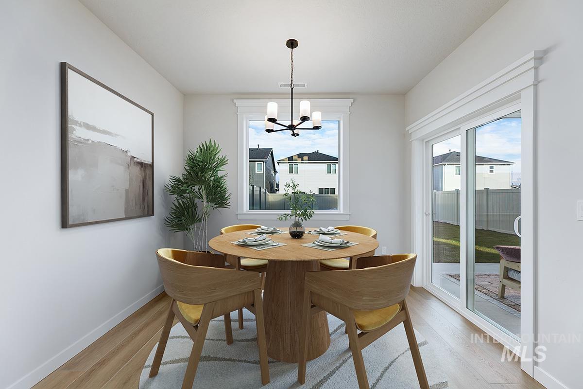 224 West Broyhill Street Meridian, ID 83642 - Photo 9 of 24 Dining area with a chandelier and light wood-type flooring