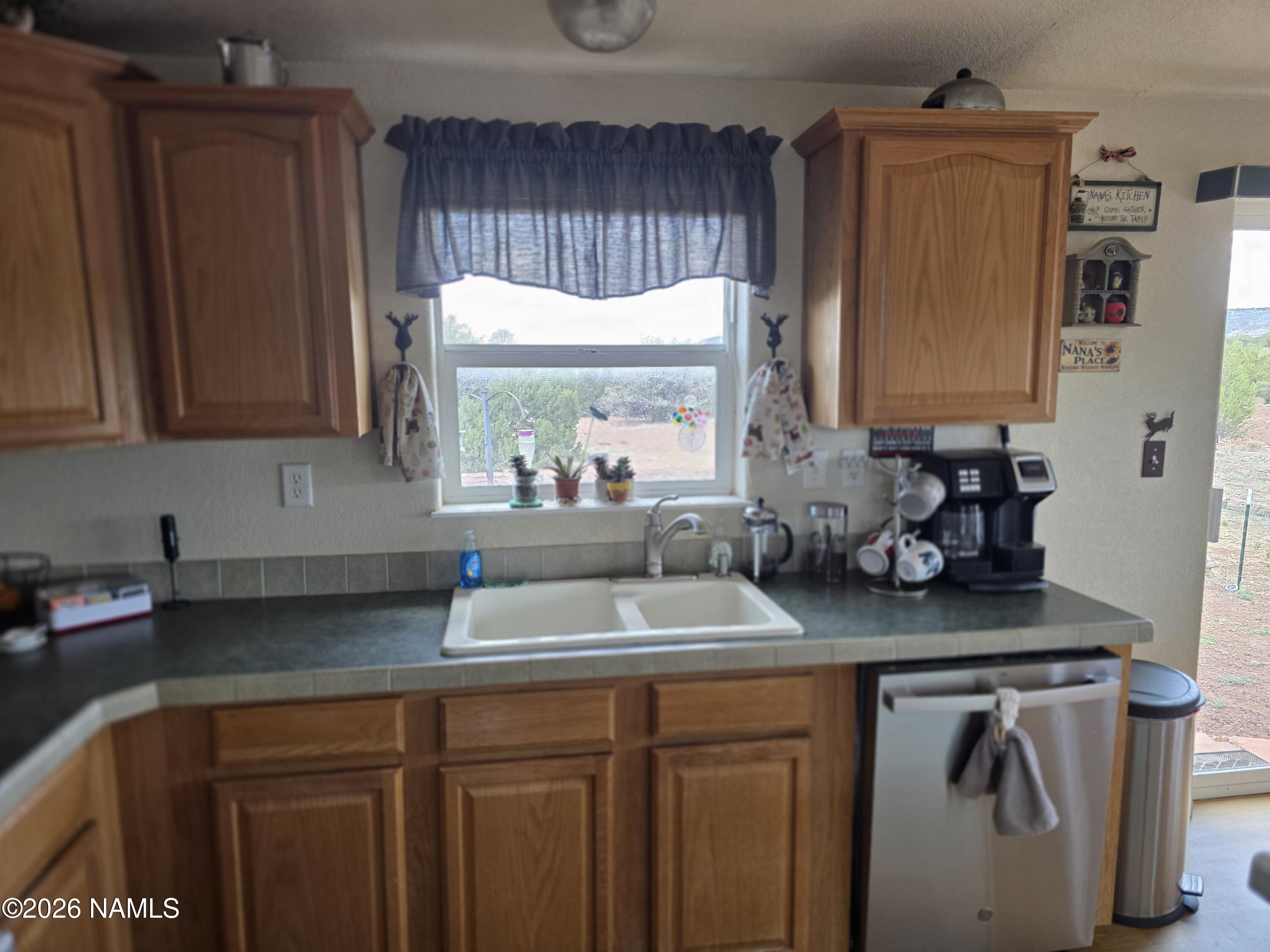 1431 East Cedar Road Williams, AZ 86046 - Photo 13 of 51 a kitchen with a sink a cabinets and window
