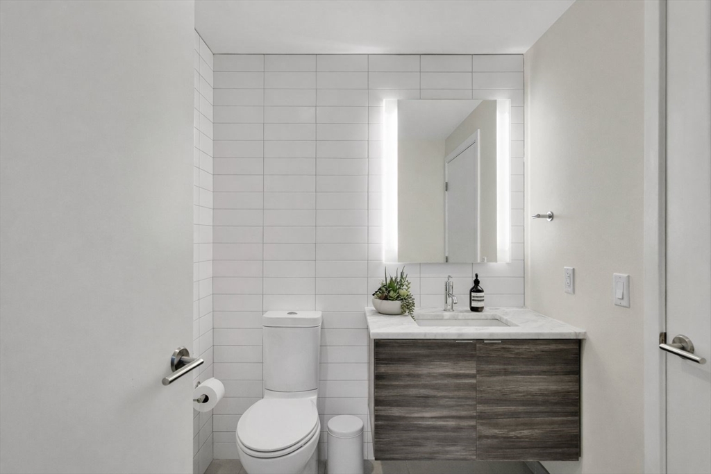 80 Fenwood Road, Unit 706 Boston, MA 02115 - Photo 12 of 33 a bathroom with a sink vanity mirror and toilet
