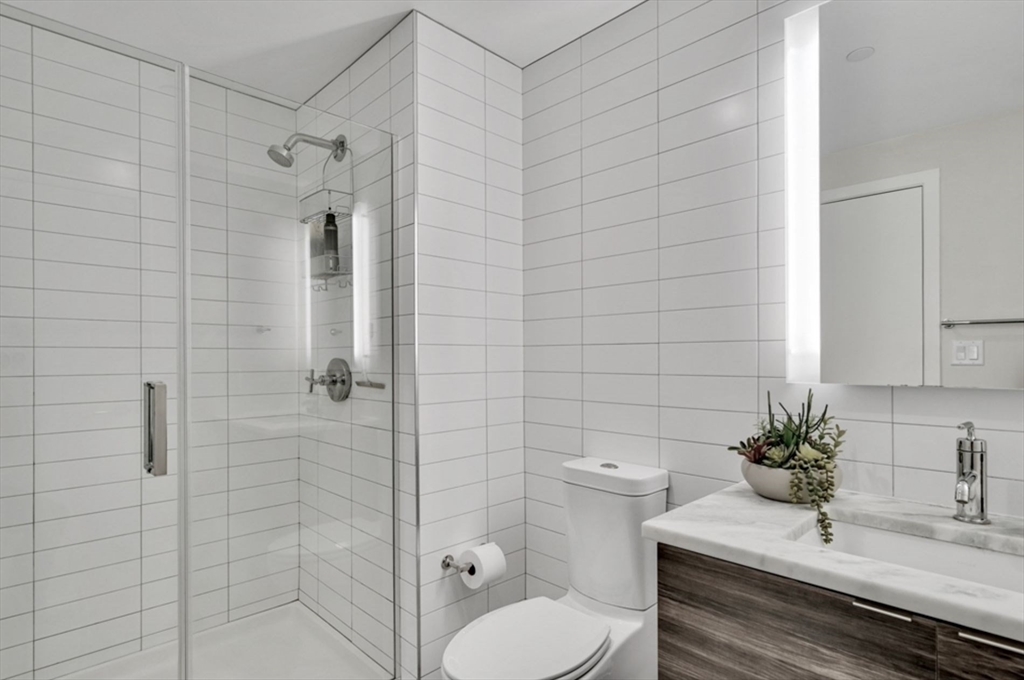 80 Fenwood Road, Unit 706 Boston, MA 02115 - Photo 13 of 33 a bathroom with a sink a toilet and shower