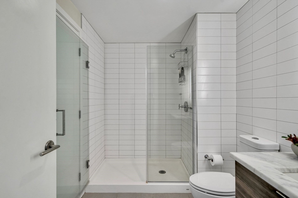 80 Fenwood Road, Unit 706 Boston, MA 02115 - Photo 15 of 33 a bathroom with a granite countertop toilet sink and shower