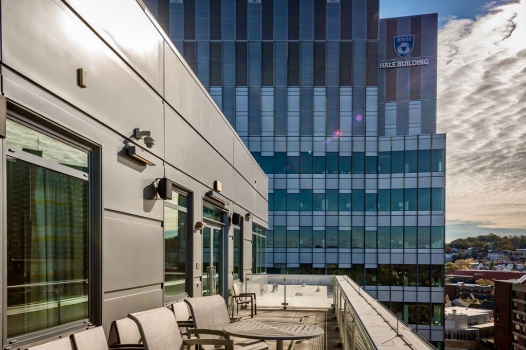80 Fenwood Road, Unit 706 Boston, MA 02115 - Photo 20 of 33 a view of a balcony with wooden floor and fence and city view