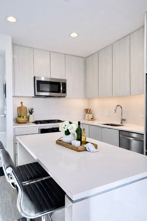 80 Fenwood Road, Unit 706 Boston, MA 02115 - Photo 3 of 33 a kitchen with a sink a stove and cabinets