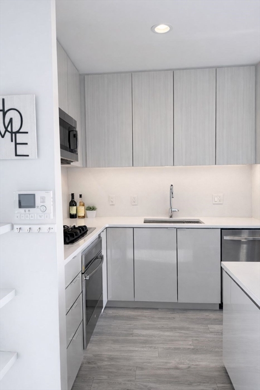80 Fenwood Road, Unit 706 Boston, MA 02115 - Photo 4 of 33 a kitchen with a sink cabinets and stainless steel appliances