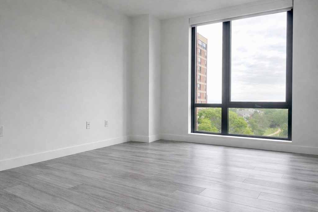 80 Fenwood Road, Unit 706 Boston, MA 02115 - Photo 5 of 33 a view of an empty room with wooden floor and a window
