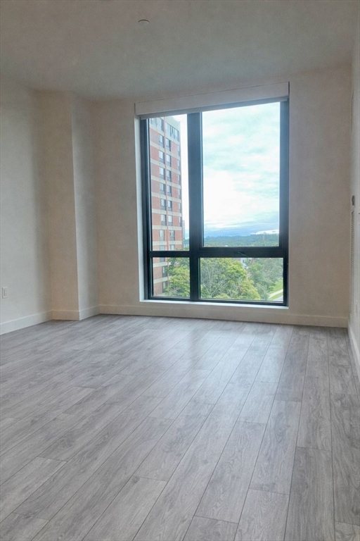 80 Fenwood Road, Unit 706 Boston, MA 02115 - Photo 7 of 33 a view of an empty room with wooden floor and a window