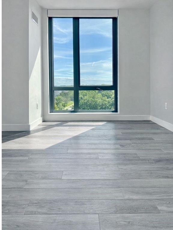 80 Fenwood Road, Unit 706 Boston, MA 02115 - Photo 8 of 33 a view of wooden floor and windows in a room