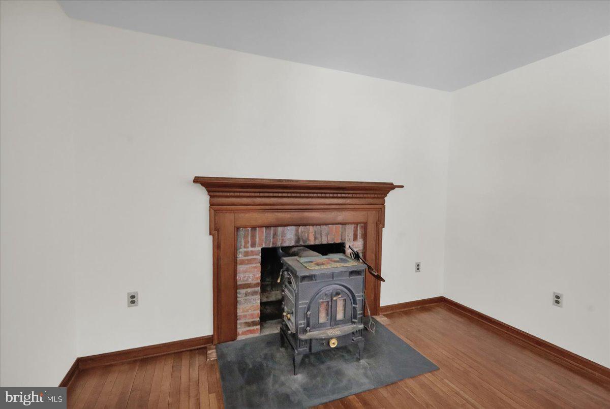 982 Fairview Road Glenmoore, PA 19343 - Photo 12 of 74 a view of livingroom with fireplace and wooden floor