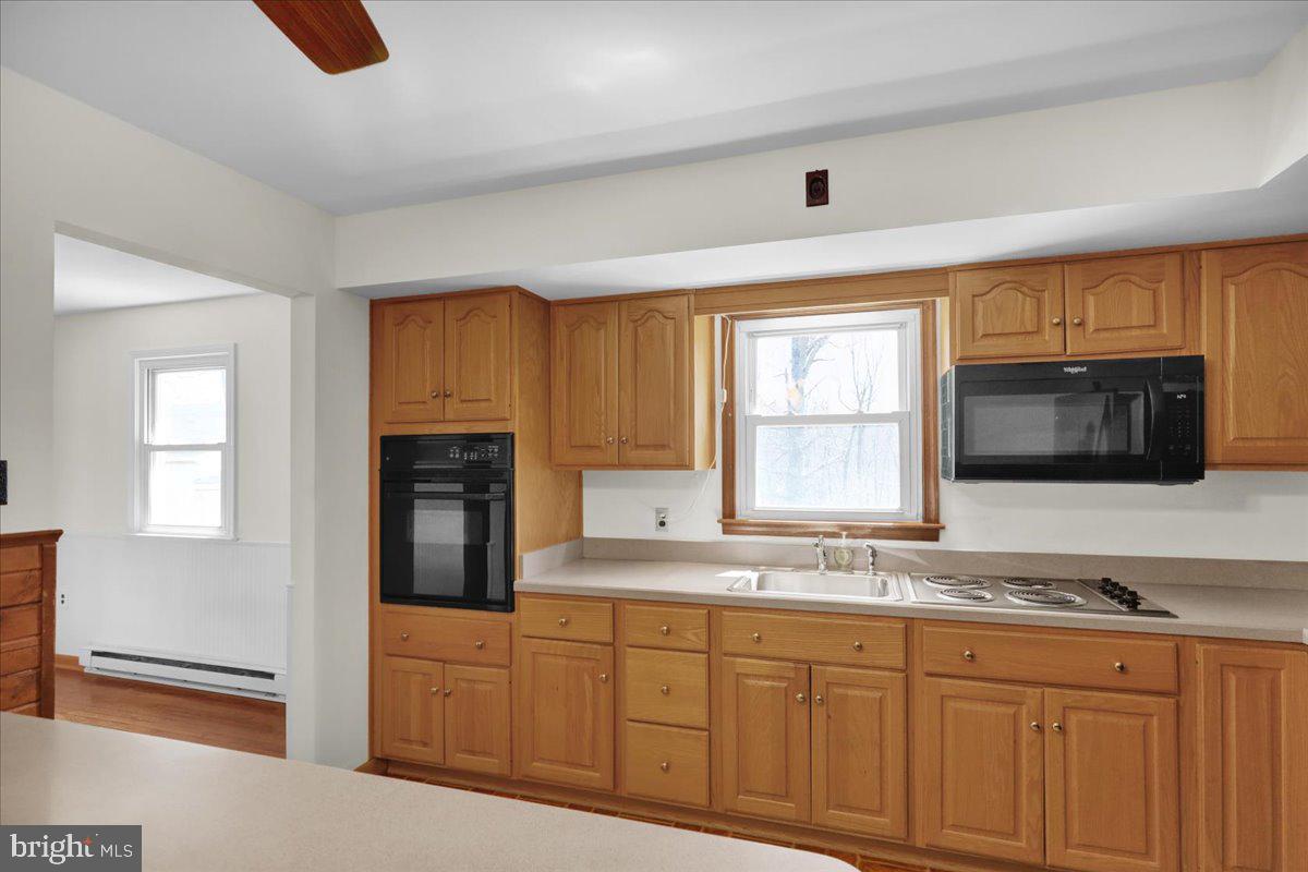 982 Fairview Road Glenmoore, PA 19343 - Photo 18 of 74 a kitchen with granite countertop a stove a sink and a microwave