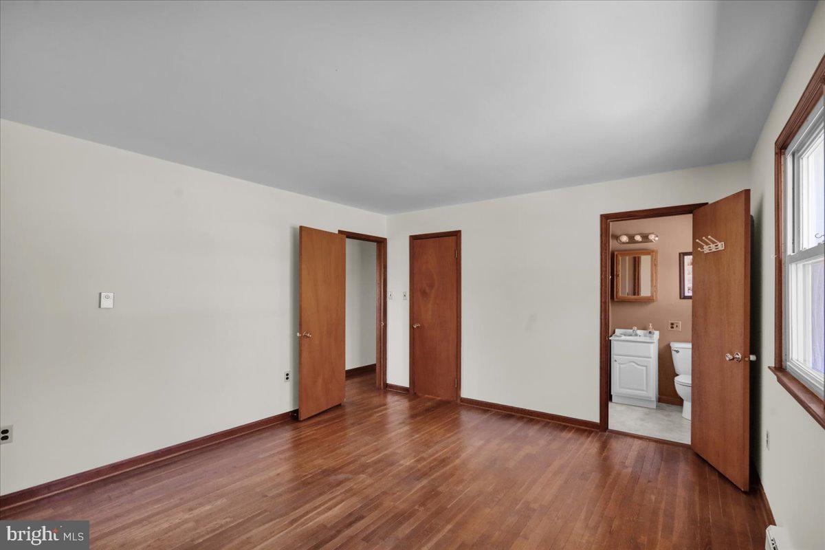 982 Fairview Road Glenmoore, PA 19343 - Photo 27 of 74 an empty room with wooden floor and windows