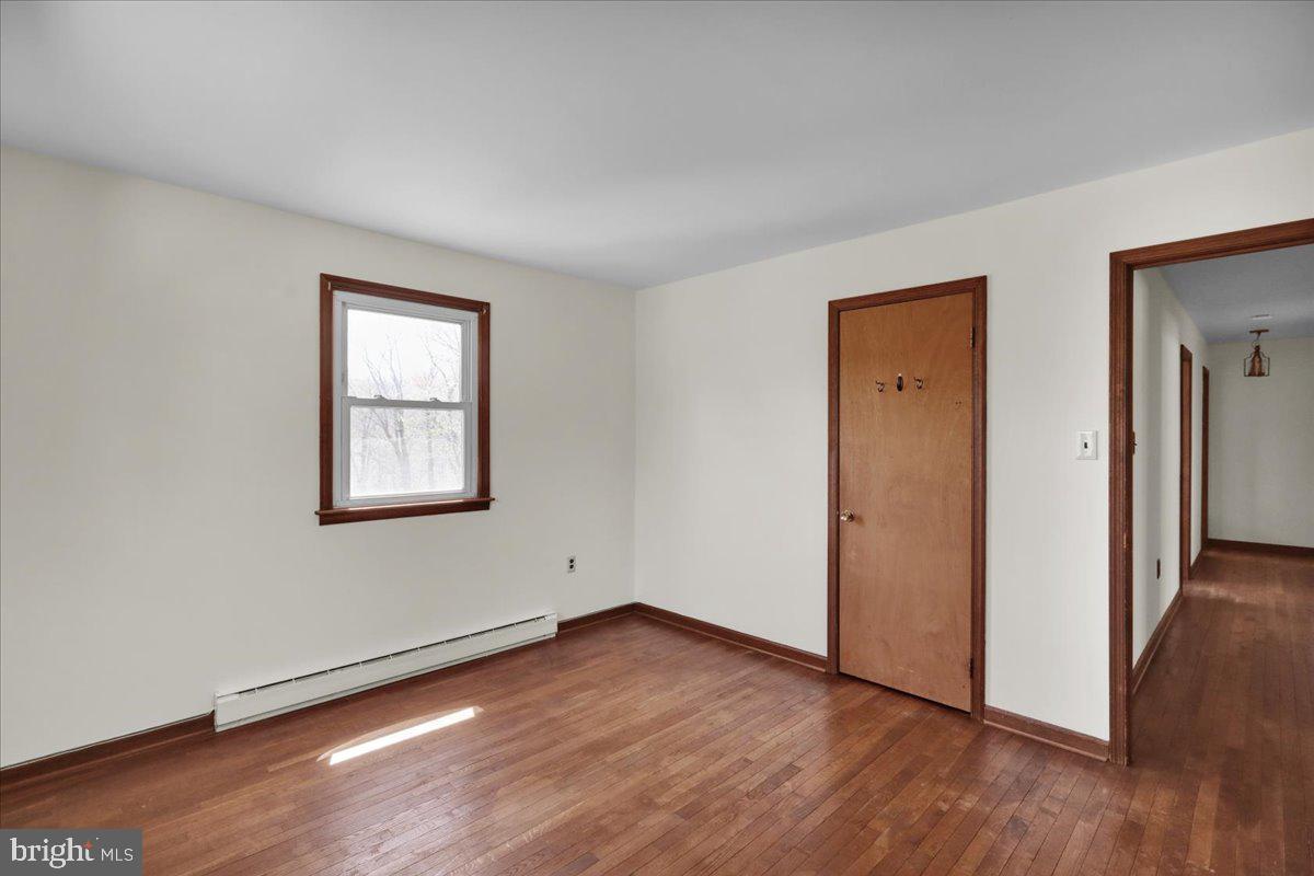 982 Fairview Road Glenmoore, PA 19343 - Photo 30 of 74 an empty room with wooden floor and closet