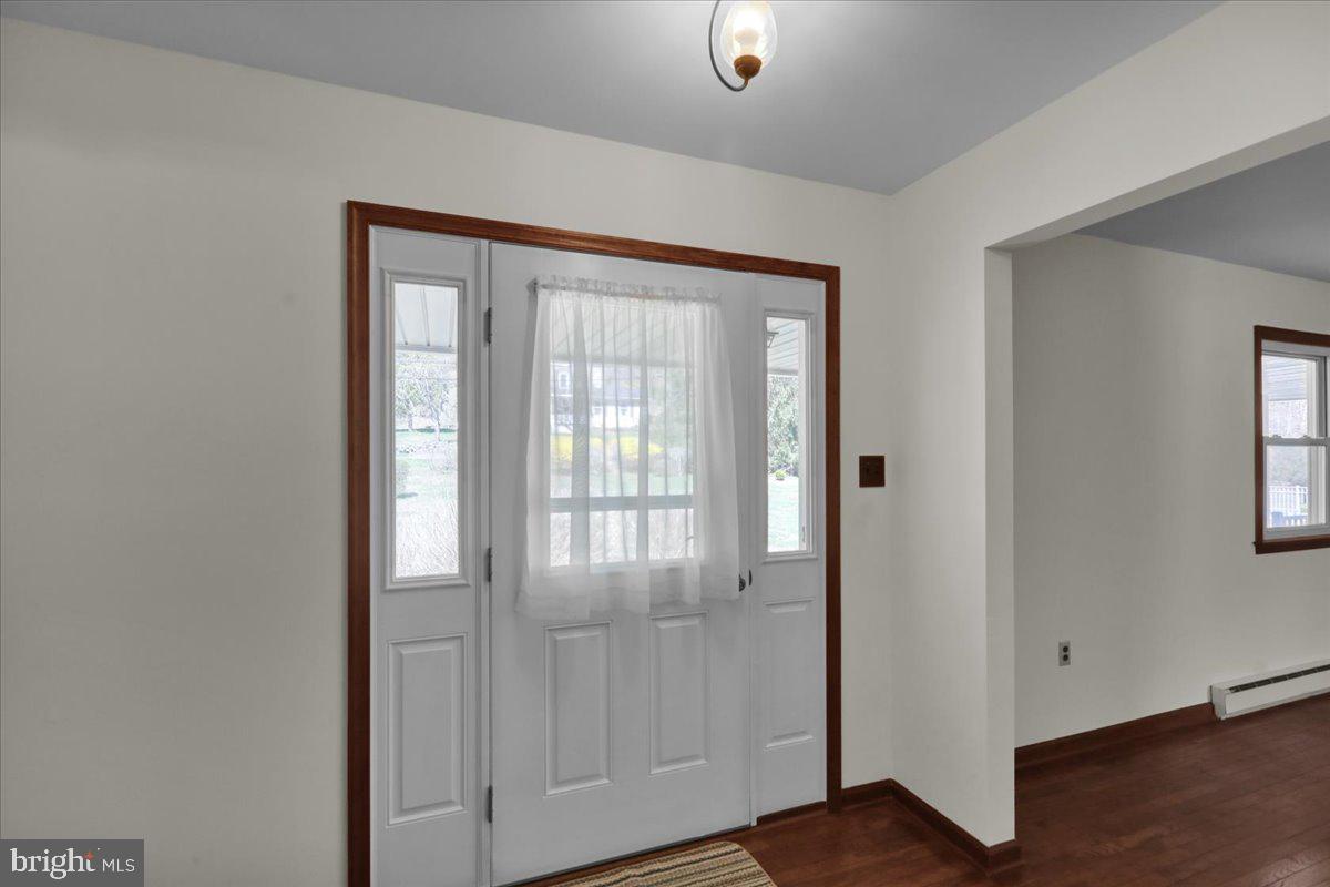 982 Fairview Road Glenmoore, PA 19343 - Photo 9 of 74 an empty room with wooden floor closet and windows