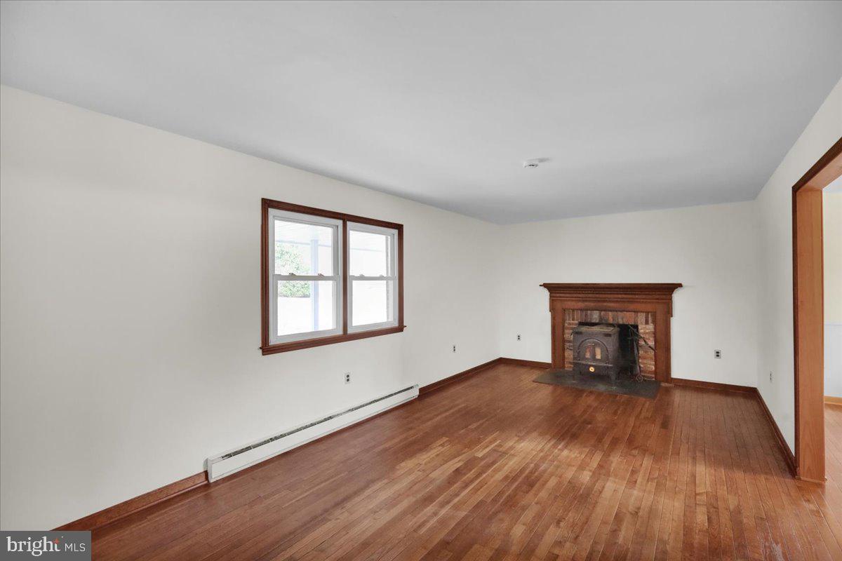 982 Fairview Road Glenmoore, PA 19343 - Photo 10 of 74 an empty room with wooden floor and windows