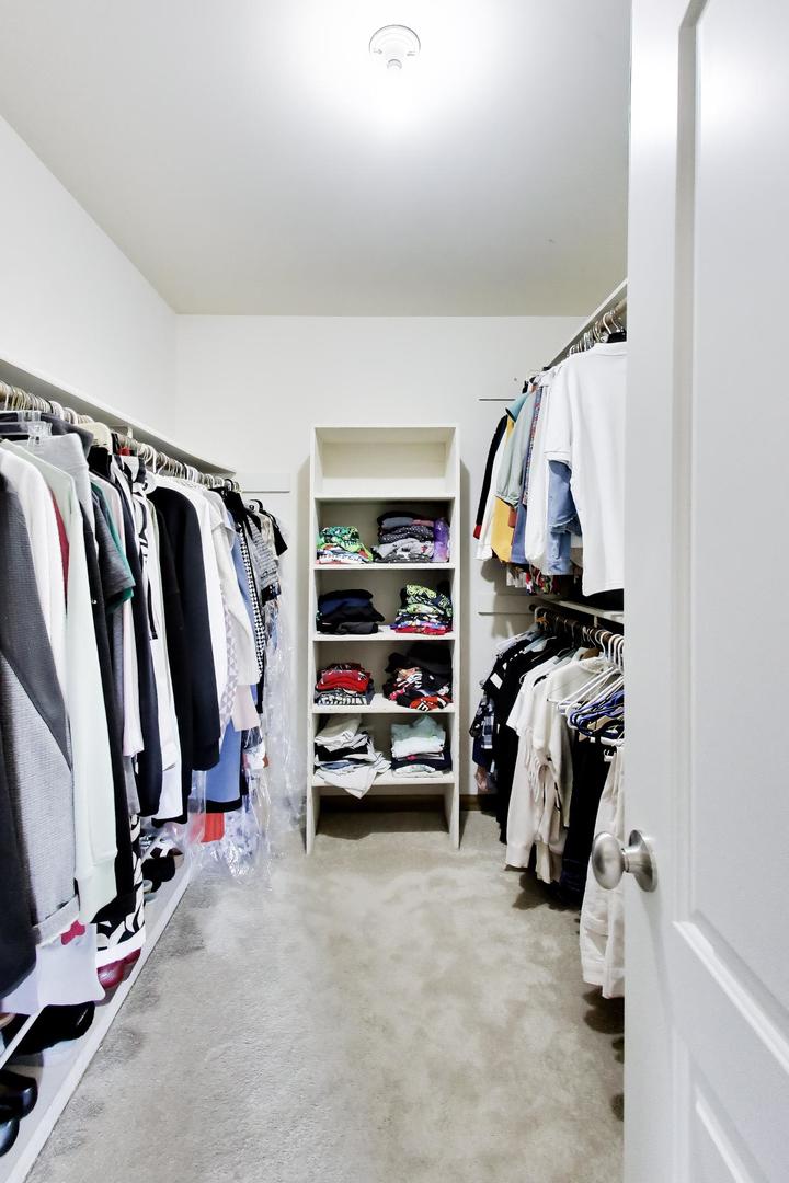 1528 Sequoia Road Naperville, IL 60540 - Photo 25 of 34 a view of walk in closet with clothes and shoes