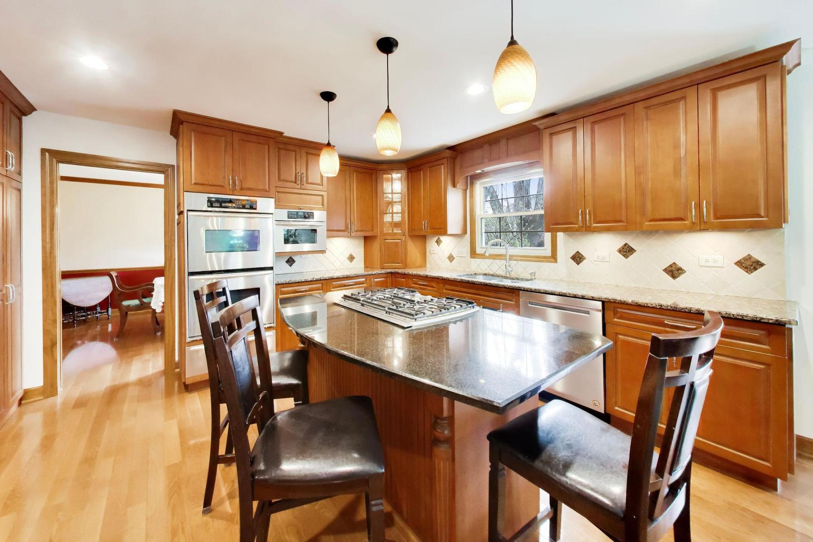 1528 Sequoia Road Naperville, IL 60540 - Photo 9 of 34 a kitchen with a table chairs refrigerator and microwave