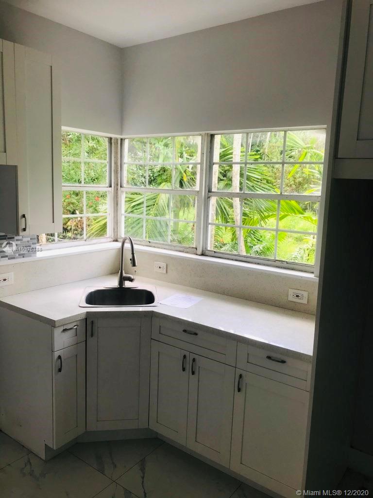 770 Northeast 77th Street Miami, FL 33138 - Photo 11 of 20 a view of a sink and dishwasher with cabinets