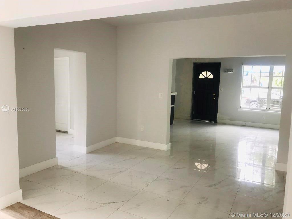 770 Northeast 77th Street Miami, FL 33138 - Photo 6 of 20 an empty room with windows and entrance