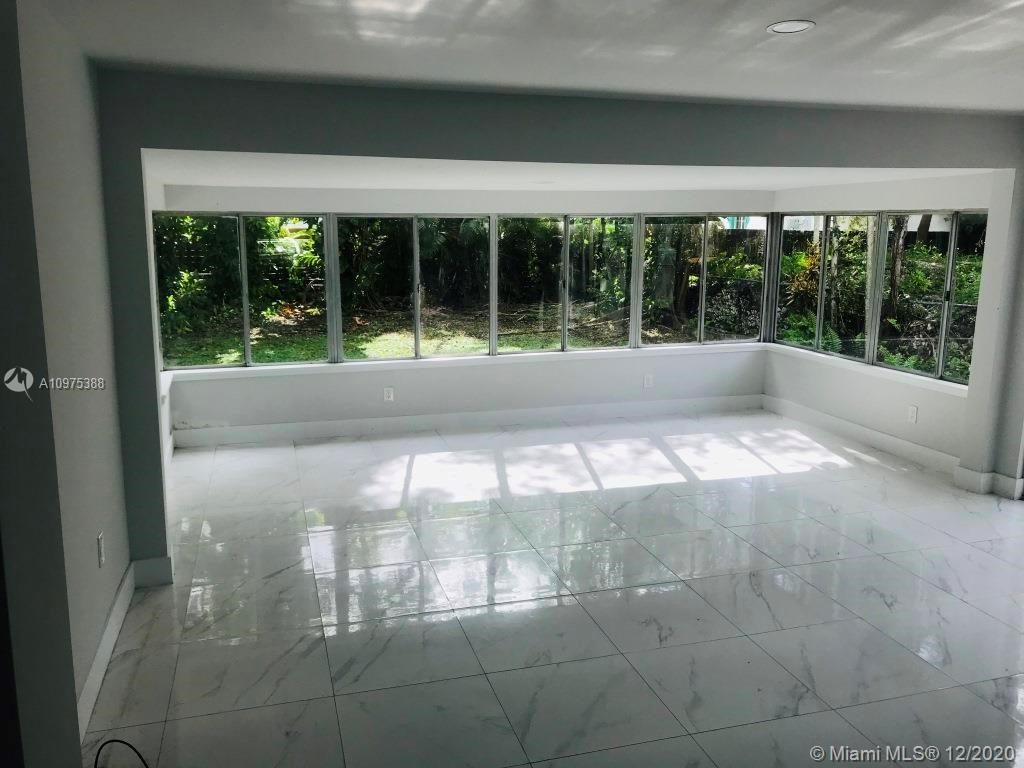 770 Northeast 77th Street Miami, FL 33138 - Photo 7 of 20 a view of a room with a large window and front door