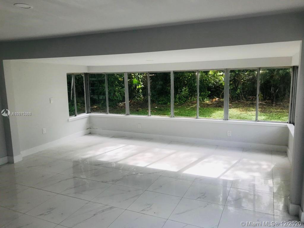 770 Northeast 77th Street Miami, FL 33138 - Photo 9 of 20 a view of backyard with a large window and a large window