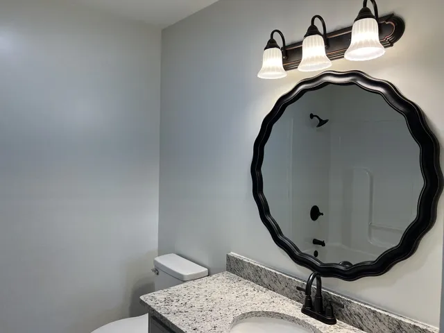 a bathroom with a sink and mirror