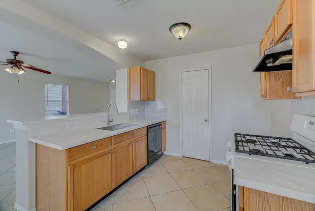 a kitchen with a sink stove and cabinets