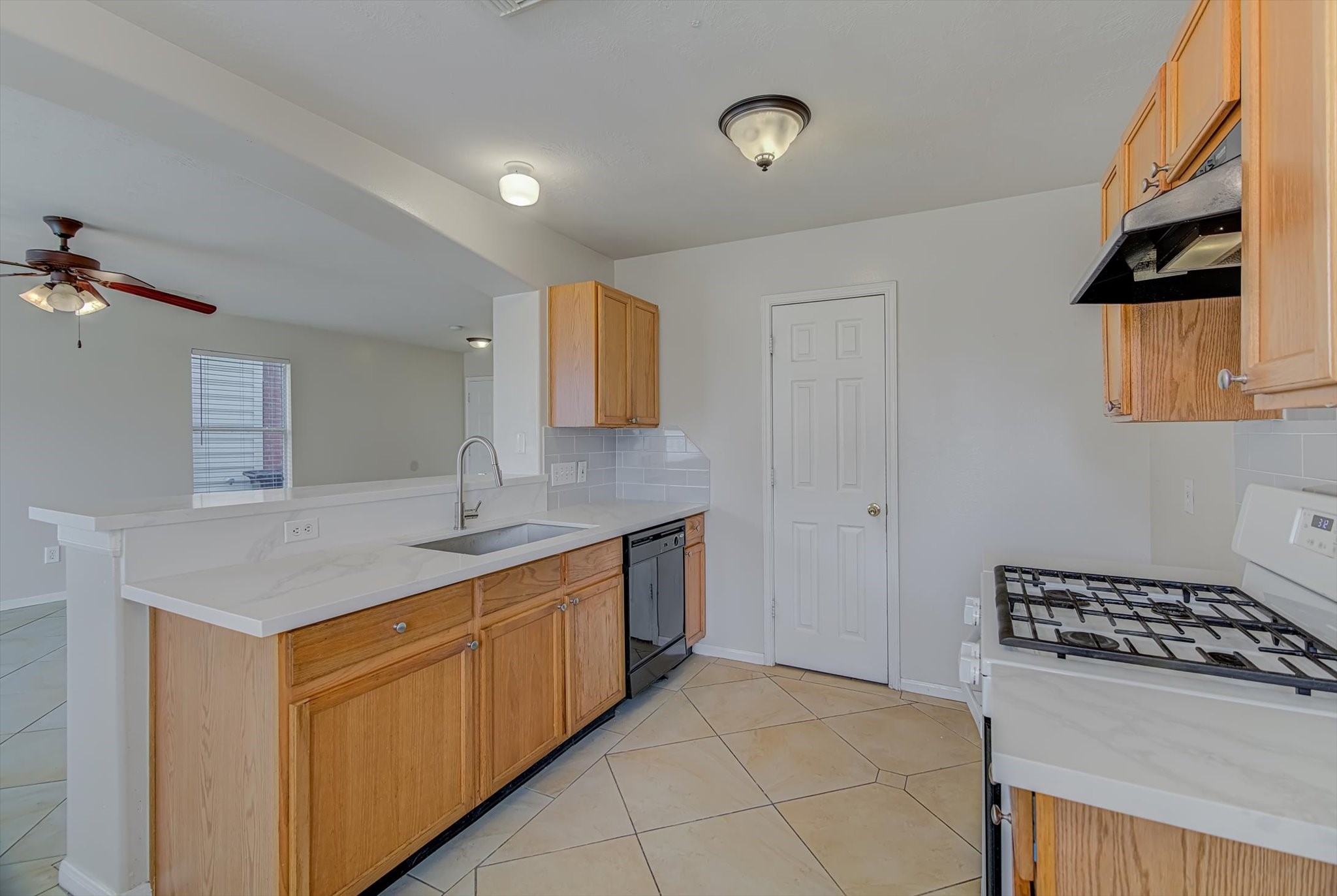 13983 Maximos Drive Houston, TX 77083 - Photo 11 of 34 a kitchen with a sink stove and cabinets