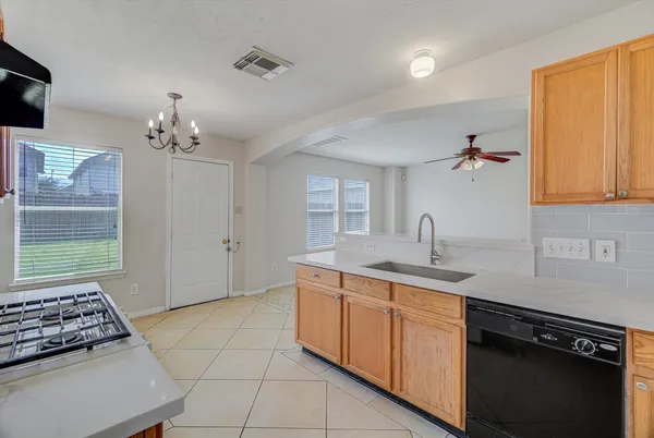 a kitchen with a sink stove and cabinets