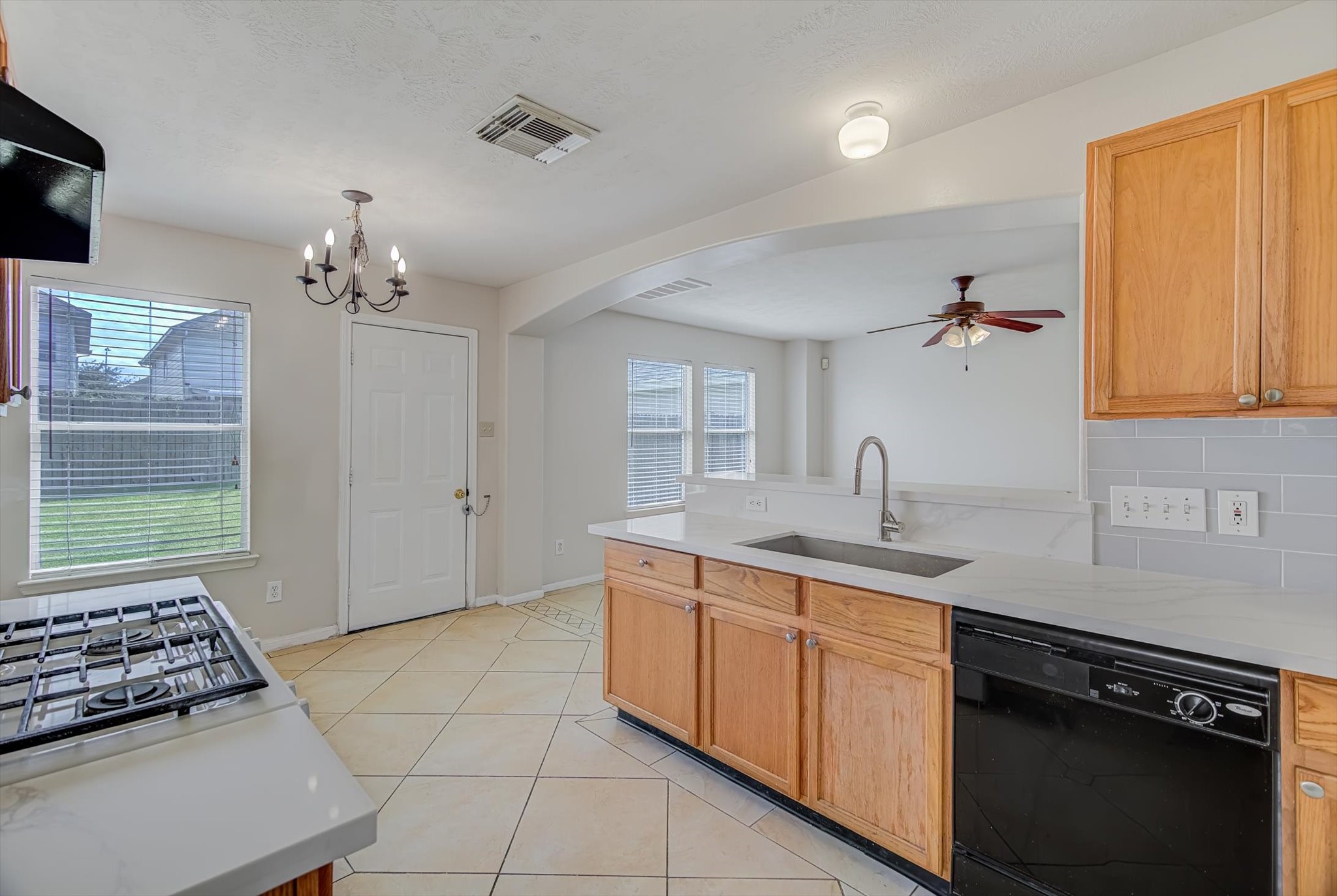 13983 Maximos Drive Houston, TX 77083 - Photo 12 of 34 a kitchen with a sink stove and cabinets