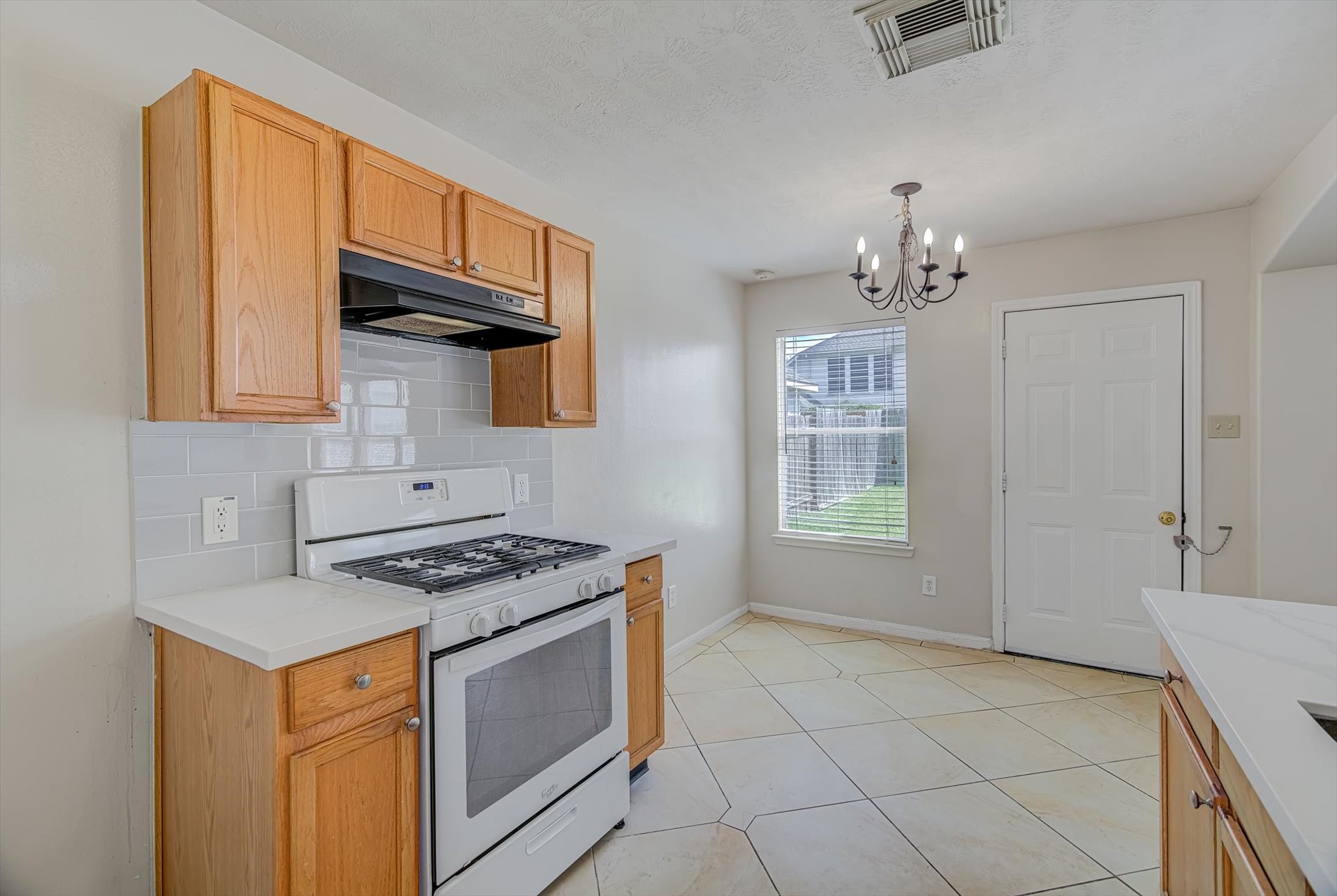 13983 Maximos Drive Houston, TX 77083 - Photo 13 of 34 a kitchen with stainless steel appliances granite countertop a stove a sink and a microwave