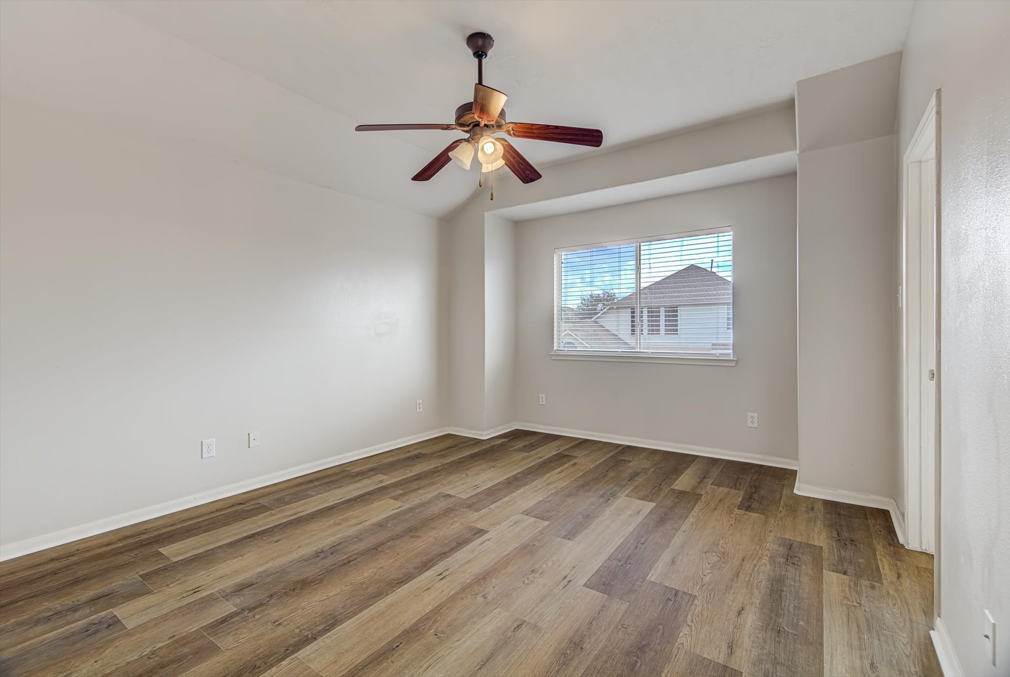 13983 Maximos Drive Houston, TX 77083 - Photo 15 of 34 a view of empty room with wooden floor and fan