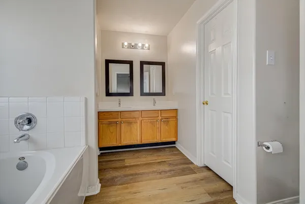 a bathroom with a tub and a sink