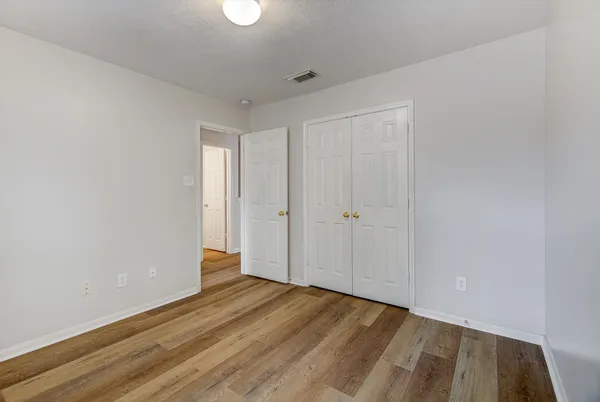 a view of hallway with wooden floor