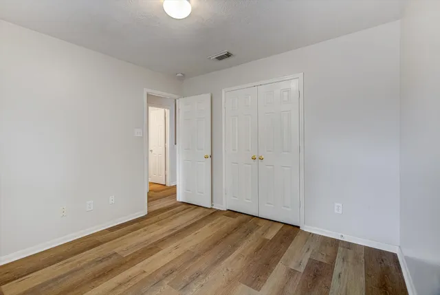 a view of hallway with wooden floor