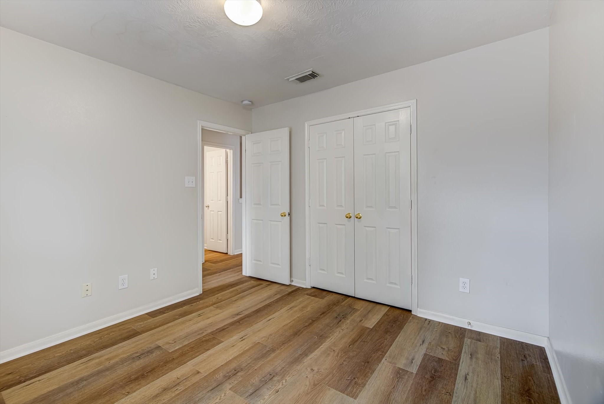 13983 Maximos Drive Houston, TX 77083 - Photo 26 of 34 a view of hallway with wooden floor