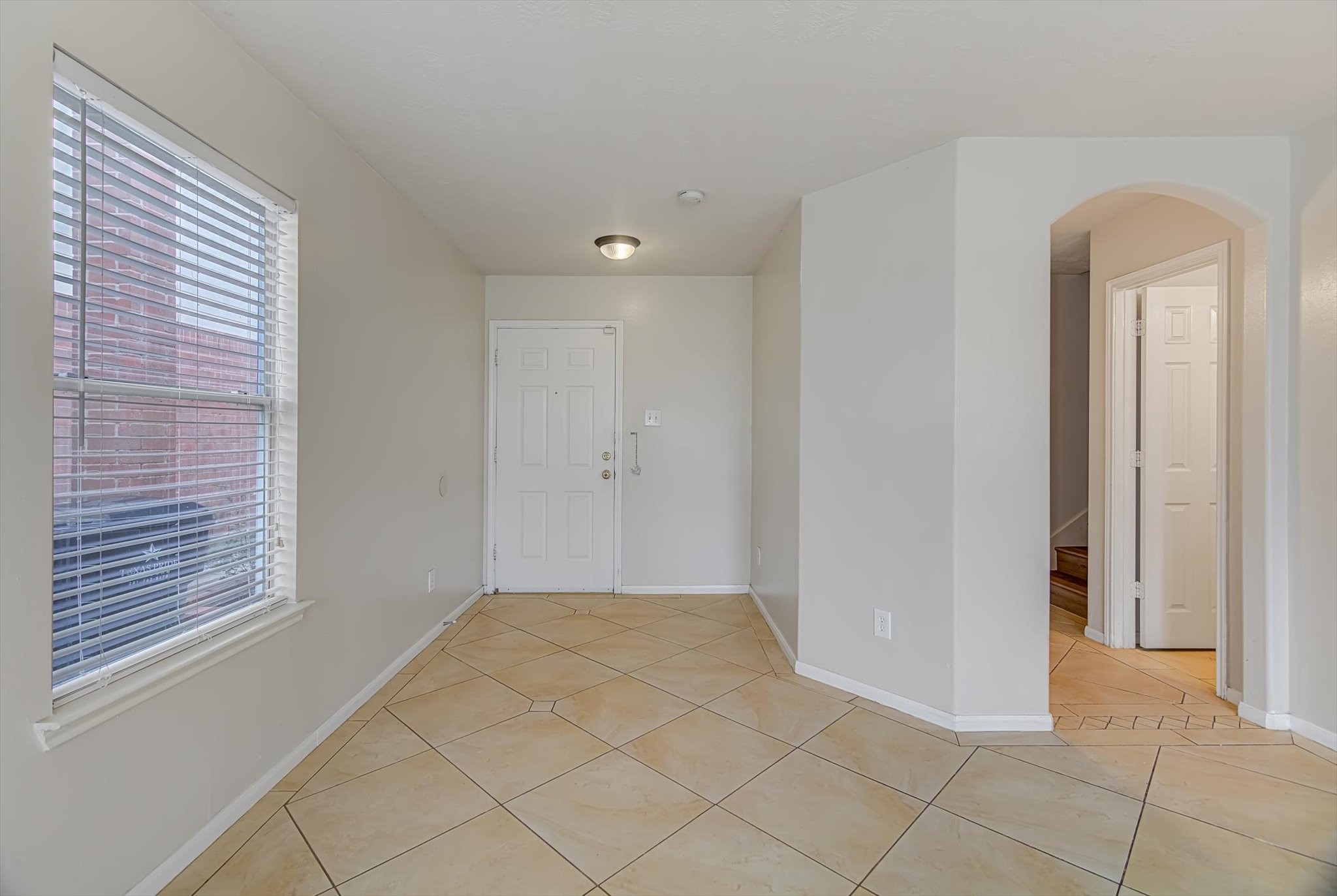 13983 Maximos Drive Houston, TX 77083 - Photo 3 of 34 a view of an empty room and window